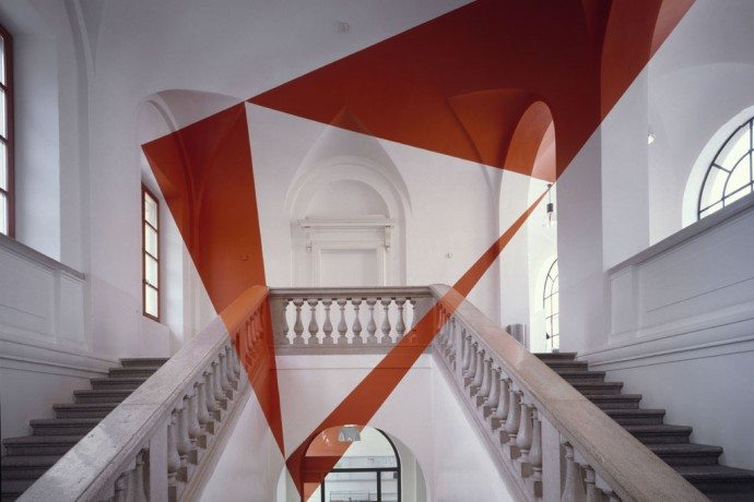 It may seem Photoshopped, but it is an optical illusion by Felice Varini. 