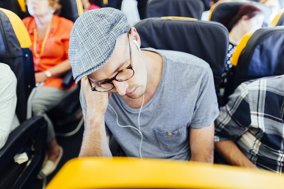 man sleeping in plane